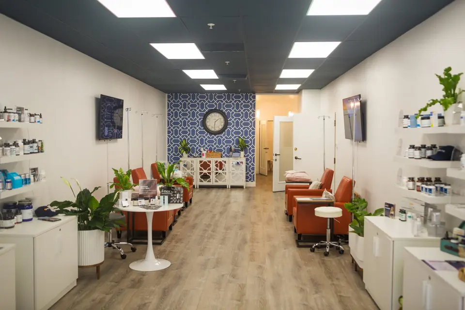 IV lounge with orange chairs and retail shelves at B12 LOVE Montclair