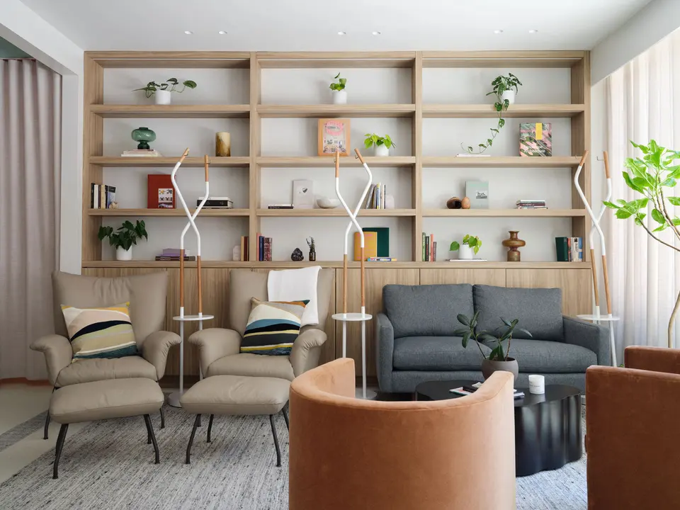Lounge with armchairs, sofa and wooden shelving at Clean Market NoHo